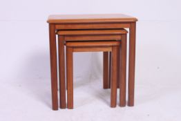 A vintage retro Danish style teak wood 1970's nest of 3 tables with graduating tops.