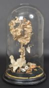 A Victorian mourning display under glass dome standing on a ebonised base please see images