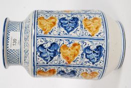 A 20th century Italian faience style albarello jar, with hand painted decoration.