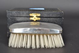 A silver hallmarked gentlemans clothes brush having monogram to centre TEW.