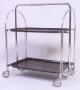 A retro 1970's metamorphic chrome metamorphic twin tier folding trolley with castors to the base.