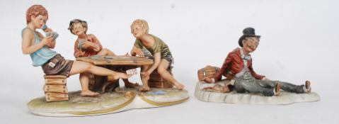 A collection of three Capo Di Monte figurines, one of card players the other two of tramps.