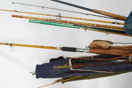 A collection of vintage fishing rods to include many examples such as split cane etc