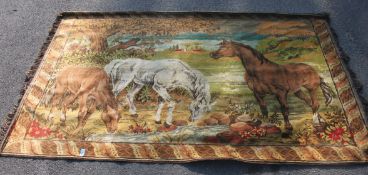 A wall hanging tapestry rug depicting Horses and other animals in a naturalistic setting