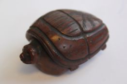 A fabulous Cacao nut incense burner in the form of a tortoise with pierced verso.