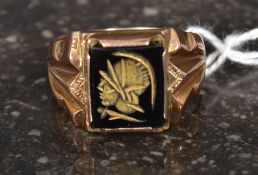 A 9ct stamped gold ring set with carved intaglio of a centurion 7.8 g gross.