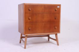 A mid 20th century retro 3 drawer veneer cabinet chest of drawers being raised on angled legs
