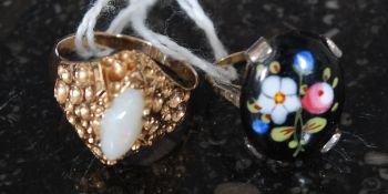Two yellow metal rings, one stamped '  9ct ( gold ) decorated with a porcelain panel,