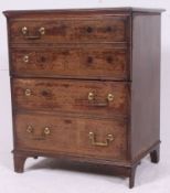 A 19th century Georgian mahogany commode chest raised on bracket feet with hinged metamorphic top