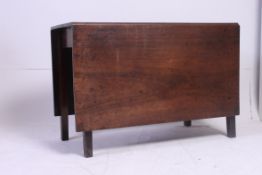 A Georgian mahogany drop leaf dining table having squared supports with solid mahogany table top.