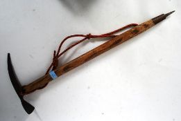 A vintage 20th century wooden and cast iron mountaineers ice pick.