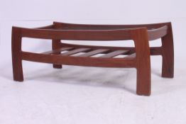 A retro 1970's teak wood Danish style coffee table of unusual form having slatted lower magazine