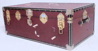 A vintage early 20th century steamer trunk having central clasps with banded exterior