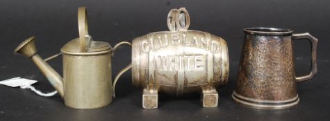 A novelty early 20th century white metal pepper condiment in the form of a watercan bearing Rd No