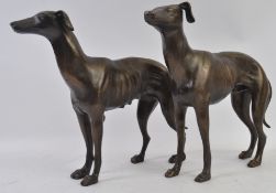 A pair of large heavy bronze effect statues of greyhounds