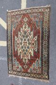A Persian decorative rug having geometric and floral decoration with central large medallion