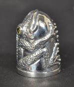 A white metal (stamped 925 silver ) frog shaped thimble with citrine eyes