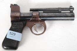 A vintage Webley Junior .177 air pistol gun, with wooden stock and impressed name to barrel.