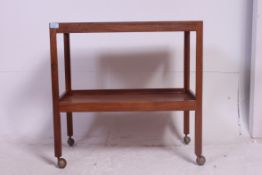 A retro 1960's Danish teak trolley having squared legs with tray tiers and castors beneath
