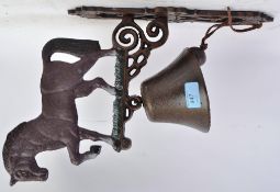 A vintage style cast metal bell in the form of a horse