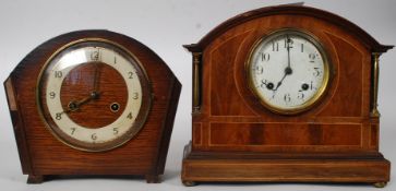 An Edwardian walnut inlaid 8 day mantel clock by Ansonia, the movement striking on a gong.