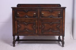 A 1920's small oak Jacobean revival sideboard.
