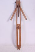 A vintage large wooden artists easel having metamorphic action previously owned by listed artist