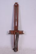 A vintage large wooden artists easel having metamorphic action previously owned by listed artist