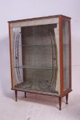 A retro 1950's formica and faux wood display cabinet having coloured sliding glass doors with lined