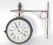 A reproduction 20th century hanging station wall clock, on hanging bracket.