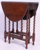 A 1920's barley twist solid oak drop leaf occasional table.