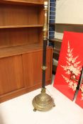An Edwardian brass adjustable telescopic standard lamp, standing on small bun brass feet,