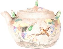 A 20th century hand made Chinese yixing teapot with relief decoration of birds and foliates.