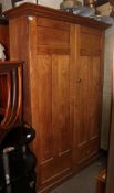 A late Victorian golden oak school cupboard.