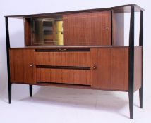 A vintage 1950's retro teak cocktail display cabinet having shaped ebonised columns with mirror