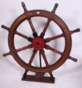 Late nineteenth century brass mounted oak and lignum vitae ships wheel with turned supports,