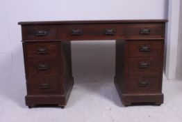 An Edwardian oak twin pedestal office desk.