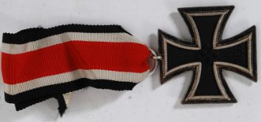 A Nazi Third Reich WW2 Iron Cross Second Class complete with ribbon marked with Swastika ,