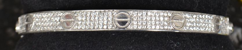 A white metal silver 925 and cz bangle in the style of Cartier