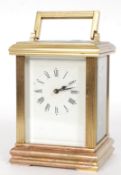 A good 20th century ACG large brass carriage clock, with white enamel dial,