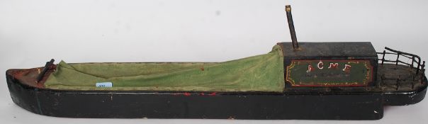 An early 20th century scratchbuilt wooden hull ( banded with metal ) model of a narrow boat -