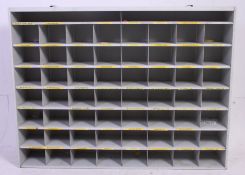 A retro industrial metal ex post office 56 hole pigeon hole cabinet.
