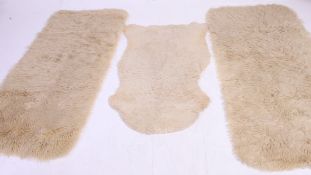 A group of vintage 20th century Sheepskin hide rugs some with labels attached to the verso.