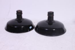 A pair of 1930's factory Industrial pendant lights having black enamel paintword with white