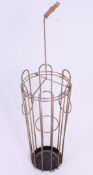 A vintage 1950's stick / umbrella stand in the form of an umbrella in wire work construction.