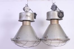 A pair of vintage Zaklady Metalow Industrial large factory pendant lights complete with the glass