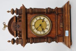 An early 20th century oak cased eight day mantle clock, glazed door, gilt circular face,