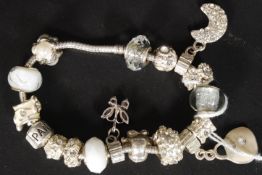 A ladies contemporary Pandora charm bracelet in silver having approximately 14 charms / beads etc (