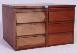 A 1970's teak wood twin office filing cabinet having beehive style drawers with flared top