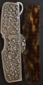 A continental silver 900 marked tortoiseshell comb and comb holder.